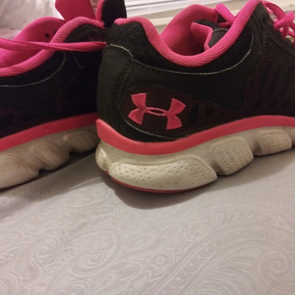 Pink and black Under Armour sneakers.
